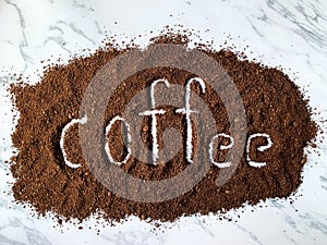 Coffee alphabet made from roasted and ground coffee beans isolated on white background
