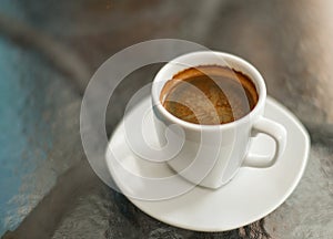 Coffee americano on the glass table, close up shot
