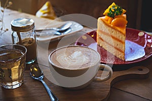 coffee aroma cup and tasty cake fruit on wood table in cafe coffee shop vintage style