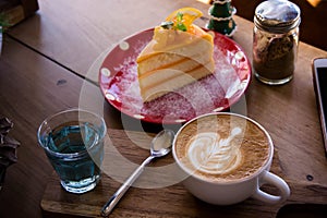 coffee aroma latte art cup and tasty christmas cake on wood table relaxtime in cafe coffee shop