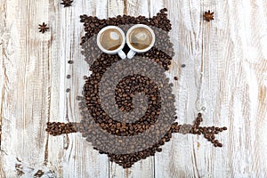 Coffee art concept ,owl from coffee beans. Coffee bean owl, Owl silhouette made with coffee beans on a coffee sack