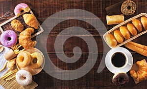 Coffee and assorted junk food multiple type on wooden table of top view with copy space