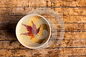 Coffee with autumn leaf on a table