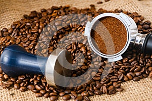 Coffee background with tamper, holder and beans
