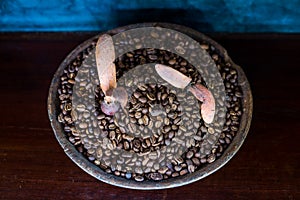 Coffee bean in earthenware jar on wooden table