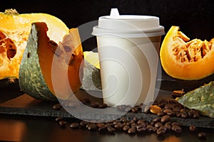 Coffee bean pumpkin spice latte nutrition recipie mock up. cut pumpkin coffee beans and white paper cup for coffee break