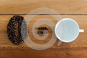Coffee bean sign made from roasted coffee beans and white cup