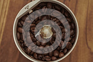 Coffee Beans and grinder on Zebrano wood table top photo