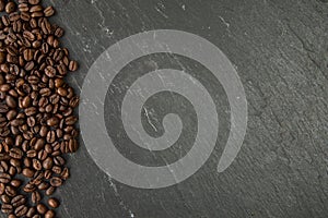 Coffee beans along a slate board