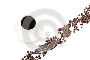 Coffee beans arranged diagonally with coffee cup on white