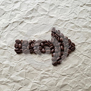 Coffee beans arranged in the shape of a right-pointing arrow
