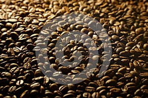 Coffee beans background with light from behind