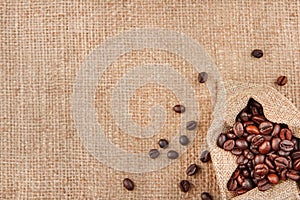 Coffee beans in a bag on a background of burlap