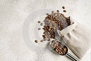 Coffee beans bag and scoop on beige