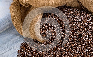 Coffee beans in a bag on wooden table