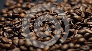 Coffee Beans on black background. Close-up dolly shot.