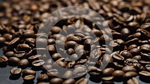 Coffee Beans on black background. Close-up dolly shot.