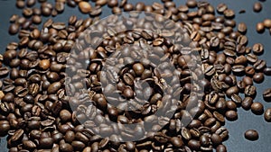 Coffee Beans on black background. Close-up dolly shot.