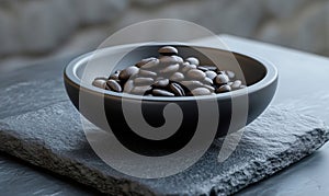 Coffee beans in black bowl, dark stone surface, natural light, minimalist design