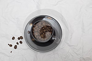 Coffee beans in black coffee cup