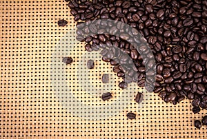 Coffee beans border on wickerwork background