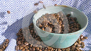 Coffee beans bouncing everywhere while inaccurately poured into a ceramic bowl in slow motion