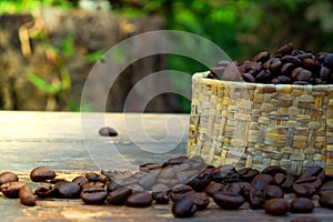 Coffee beans in bulk on wood table and a soft light.