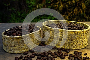 Coffee beans in bulk on wood table and a soft light.