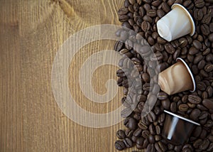 Coffee Beans and Capsules on Wooden Background Top View Copy Space