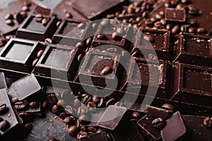 Coffee beans with chocolate dark chocolate. Broken slices of chocolate. Chocolate bar pieces.