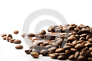 Coffee beans and chocolate pieces on white