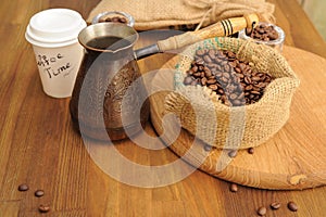 Coffee beans in cloth bag, take away paper cup and cezve