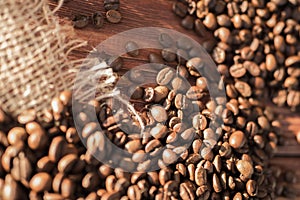 Coffee beans on a table with burlap.