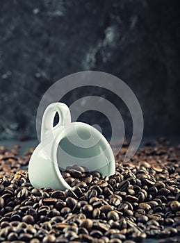 Coffee beans. Coffee cup full of coffee beans. Toned image
