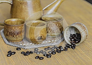 Coffee beans and coffee cups set on wooden background.Vintage style.(soft focus)