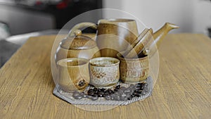 Coffee beans and coffee cups set on wooden background.Vintage style.(soft focus)