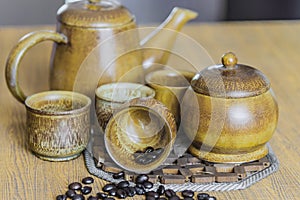 Coffee beans and coffee cups set on wooden background.Vintage style.(soft focus)