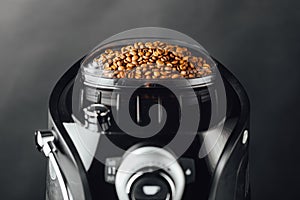Coffee beans in coffeemaker bean container, close-up view photo