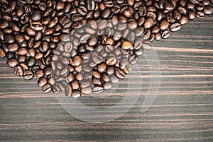 Coffee beans concept on wooden table background.