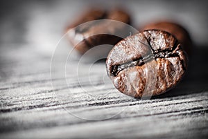 Coffee beans concept on wooden table background.