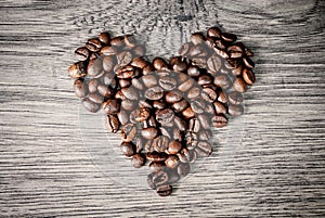 Coffee beans concept on wooden table background.