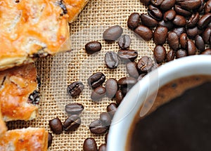 Coffee beans with cookies and cup of coffee