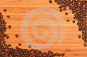 Coffee beans corners over bamboo wood background