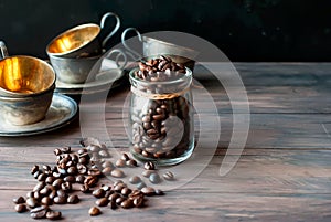 Coffee beans in a cristal jar on a brown wooden background