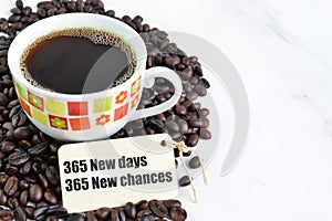Coffee beans, a cup of coffee and label tag written with 365 NEW DAYS, 365 NEW CHANCES