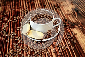 Coffee beans in a cup with cookies