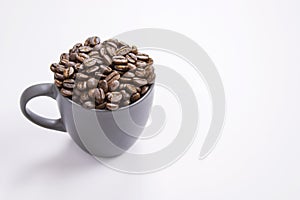 Coffee beans in dark coffee cup on  white background