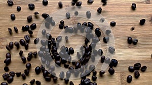 Coffee beans droped on wood board.