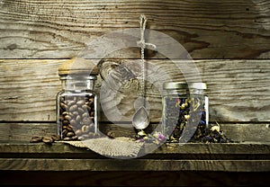 Coffee beans and dry tea in glass jars