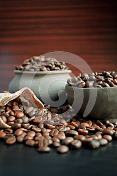 Coffee beans in an earthenware dish and a bag.